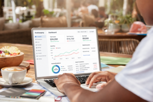 Restaurant owner using a computer to reconcile DoorDash and Uber Eats delivery payouts in QuickBooks